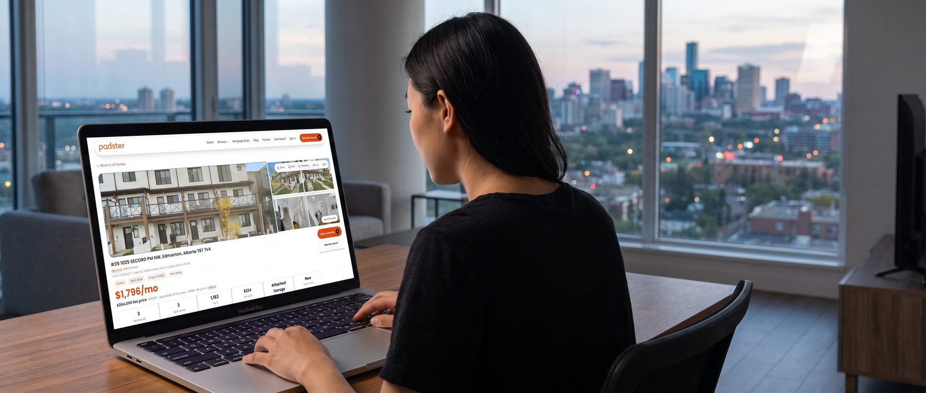 A Canadian real estate listing open on a laptop, Edmonton skyline behind